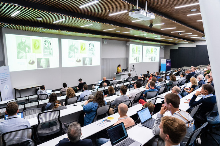 Group of conference attendees in a lecture theatre during the keynote presentation